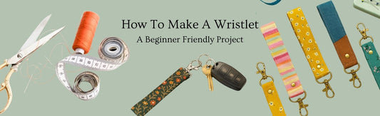 Flat lay of sewing tools and colourful fabric wristlet keychains with the text ‘How To Make A Wristlet – A Beginner Friendly Project’ on a pale green background.