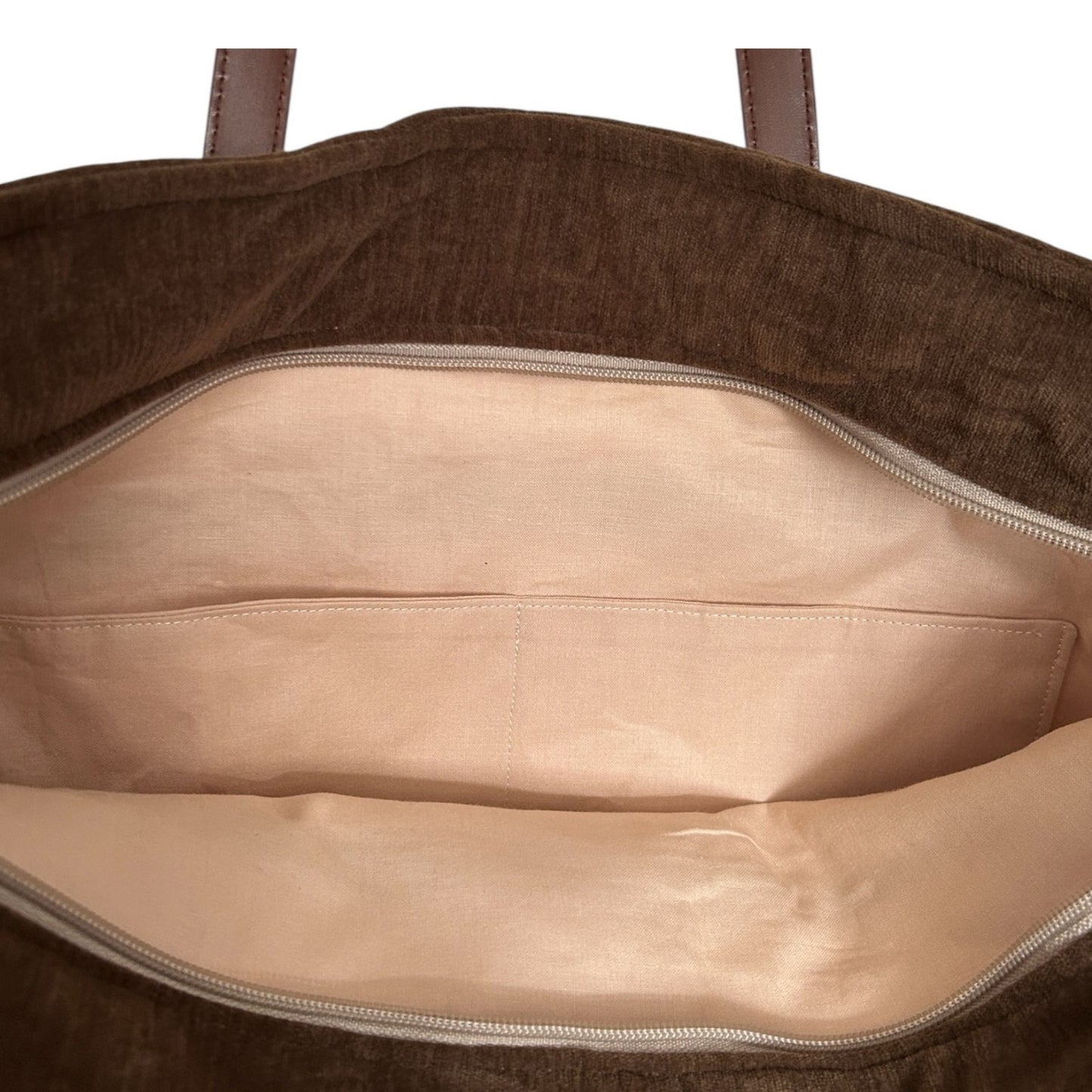 Brown garment bag with beige interior on a white background