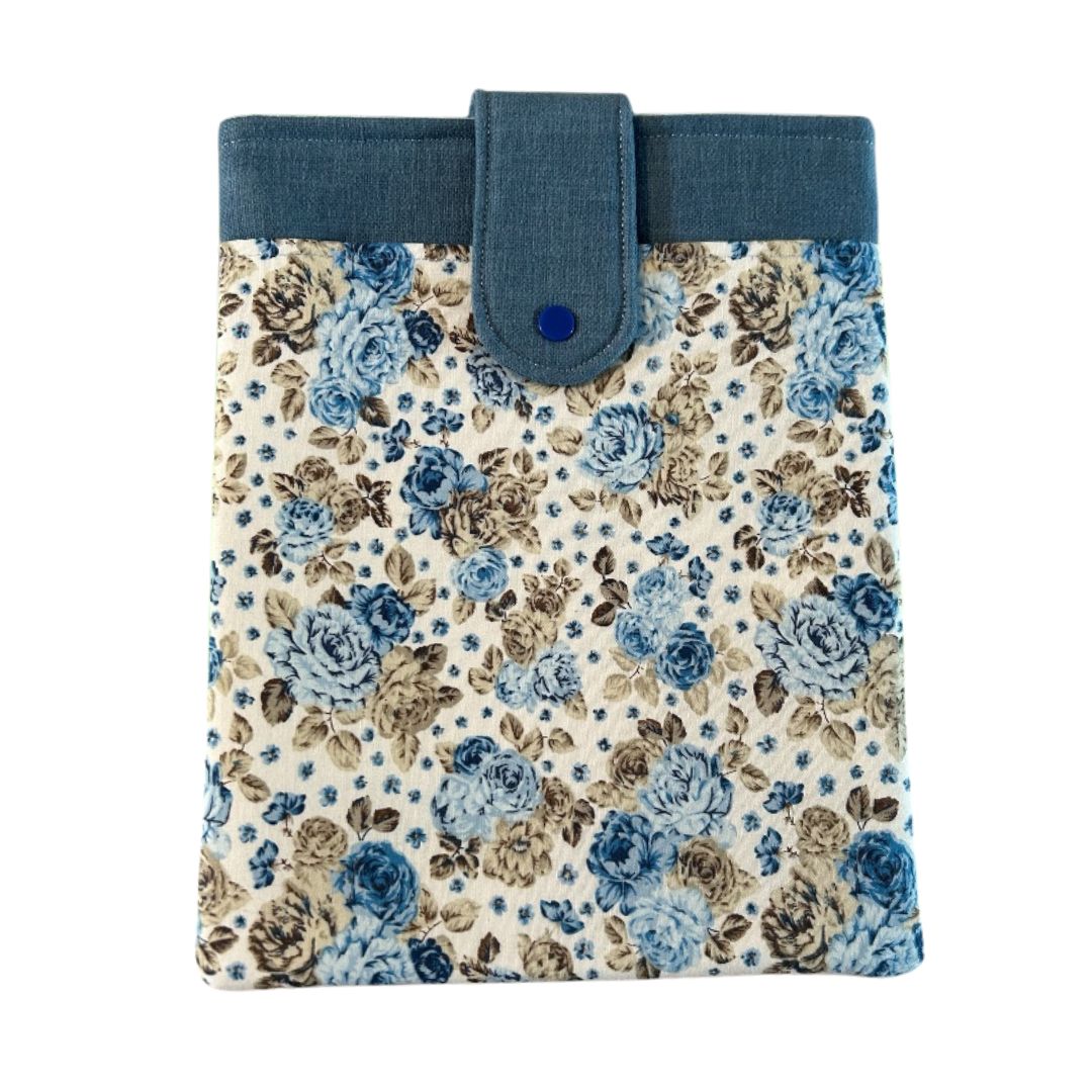 Blue floral tablet sleeve with snap closure and denim-style top trim, handmade from repurposed fabric.