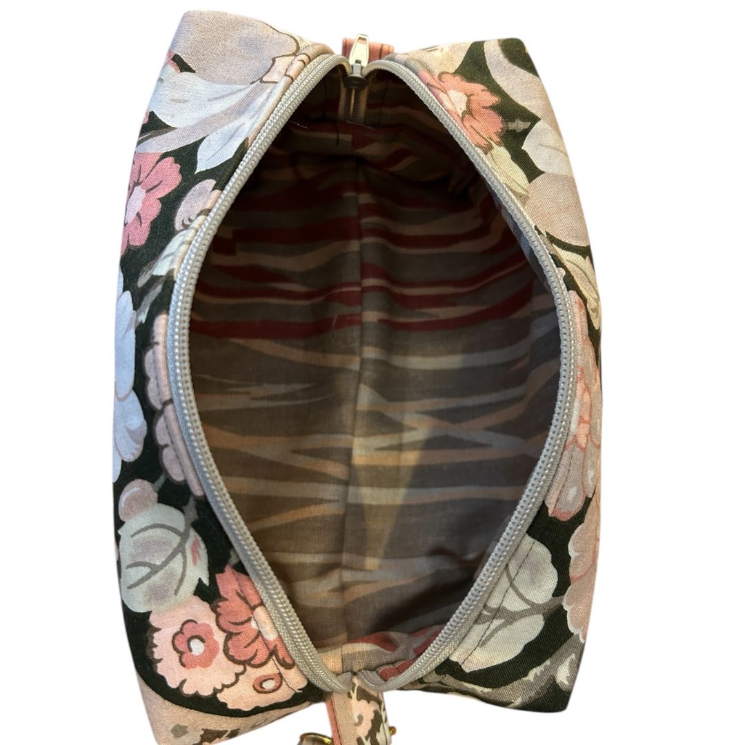 Top-down view of a handmade brown floral pouch showing the spacious interior and coordinating striped cotton lining.