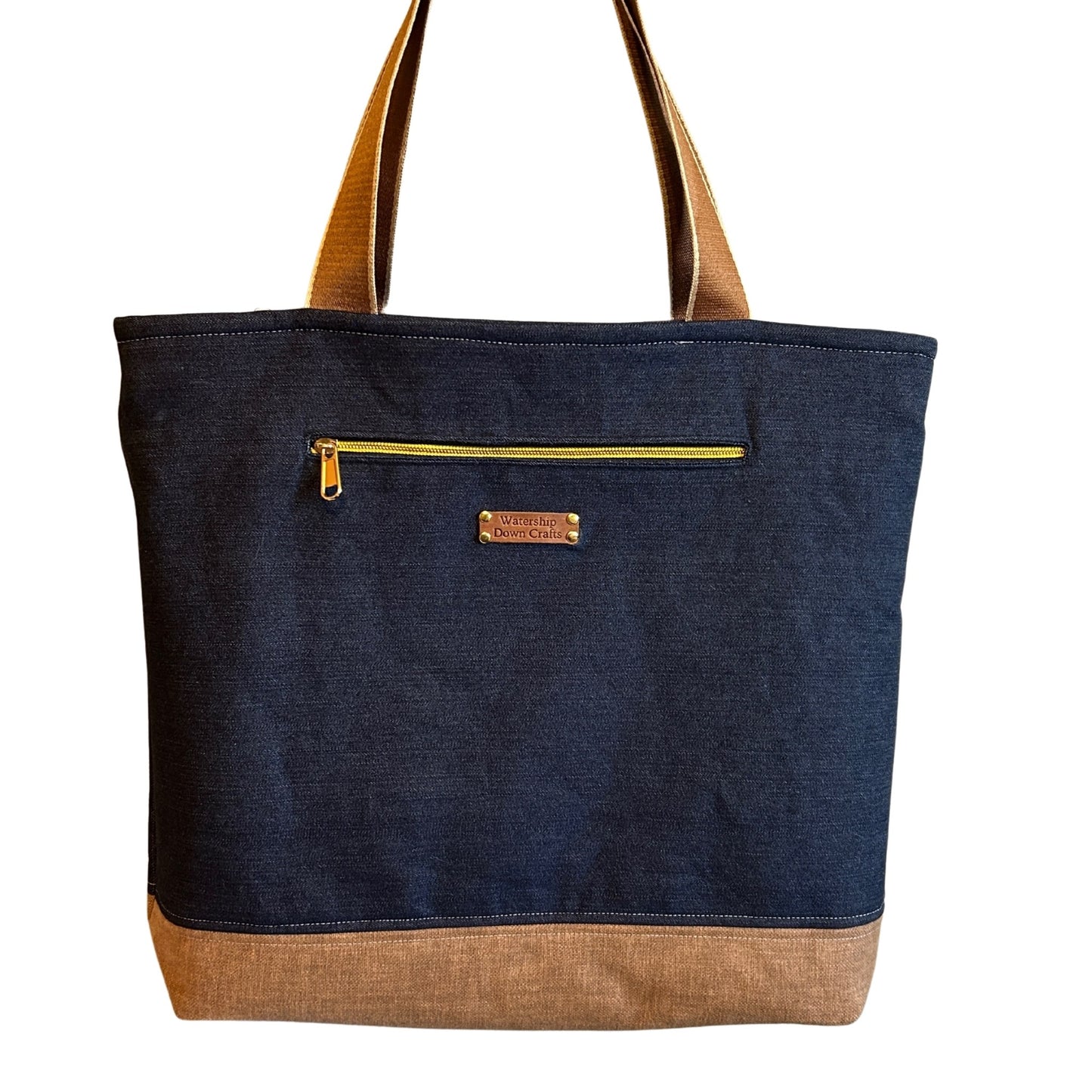 Blue tote bag with brown base and handles on a white background