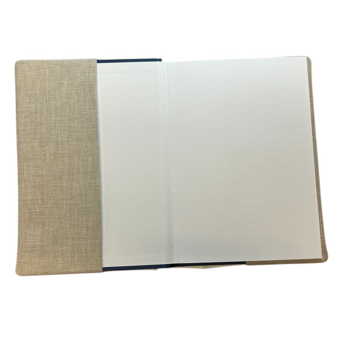 Interior view of a handmade notebook cover, showing a lined notebook securely held inside a fabric sleeve.