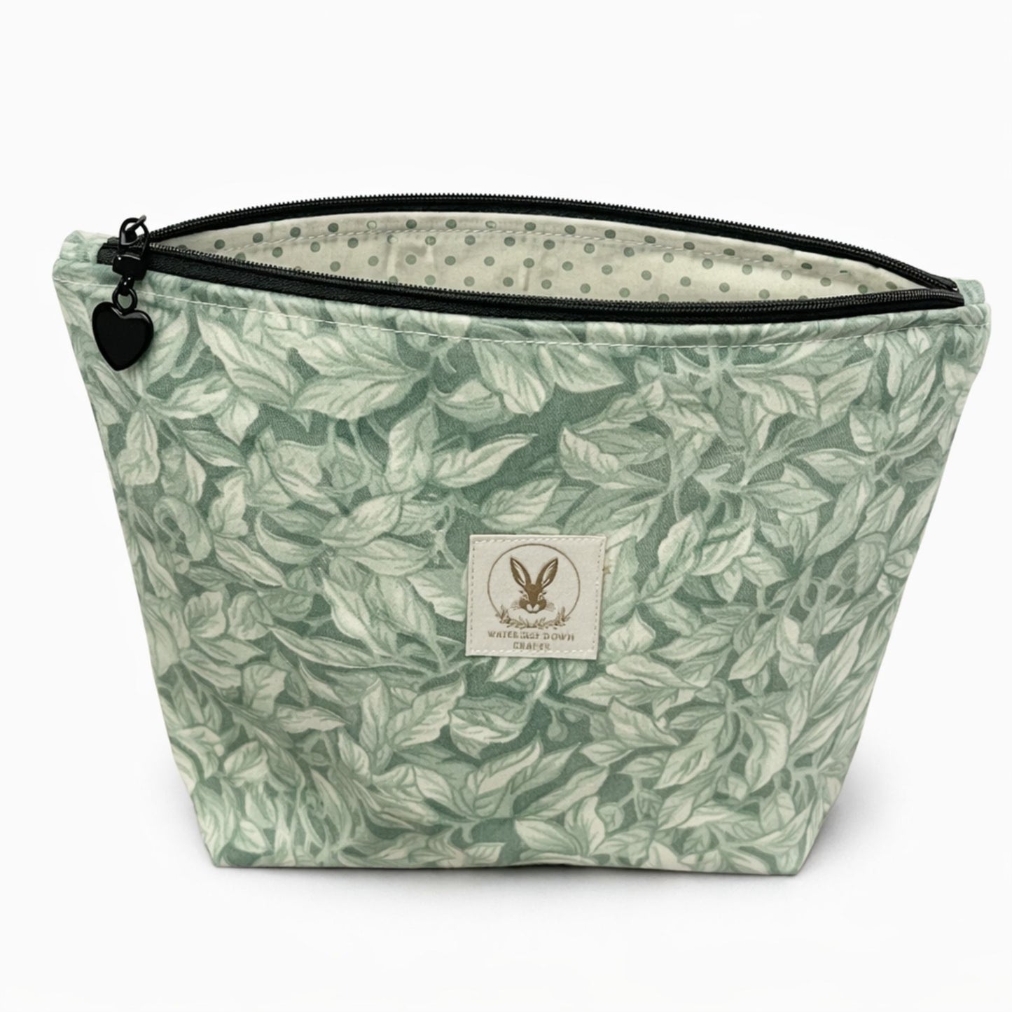 Green leaf-patterned pouch with a brand label on a white background