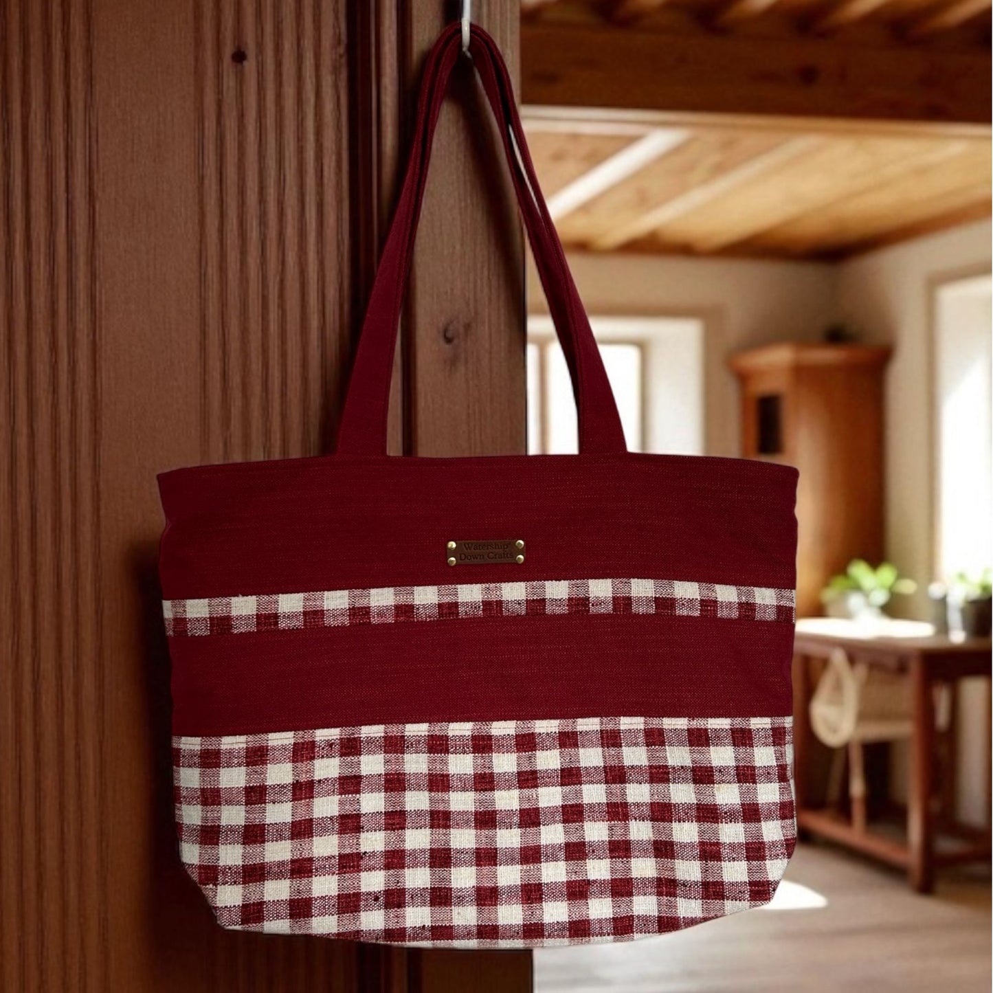 Red tote bag with checkered pattern hanging on a wooden door