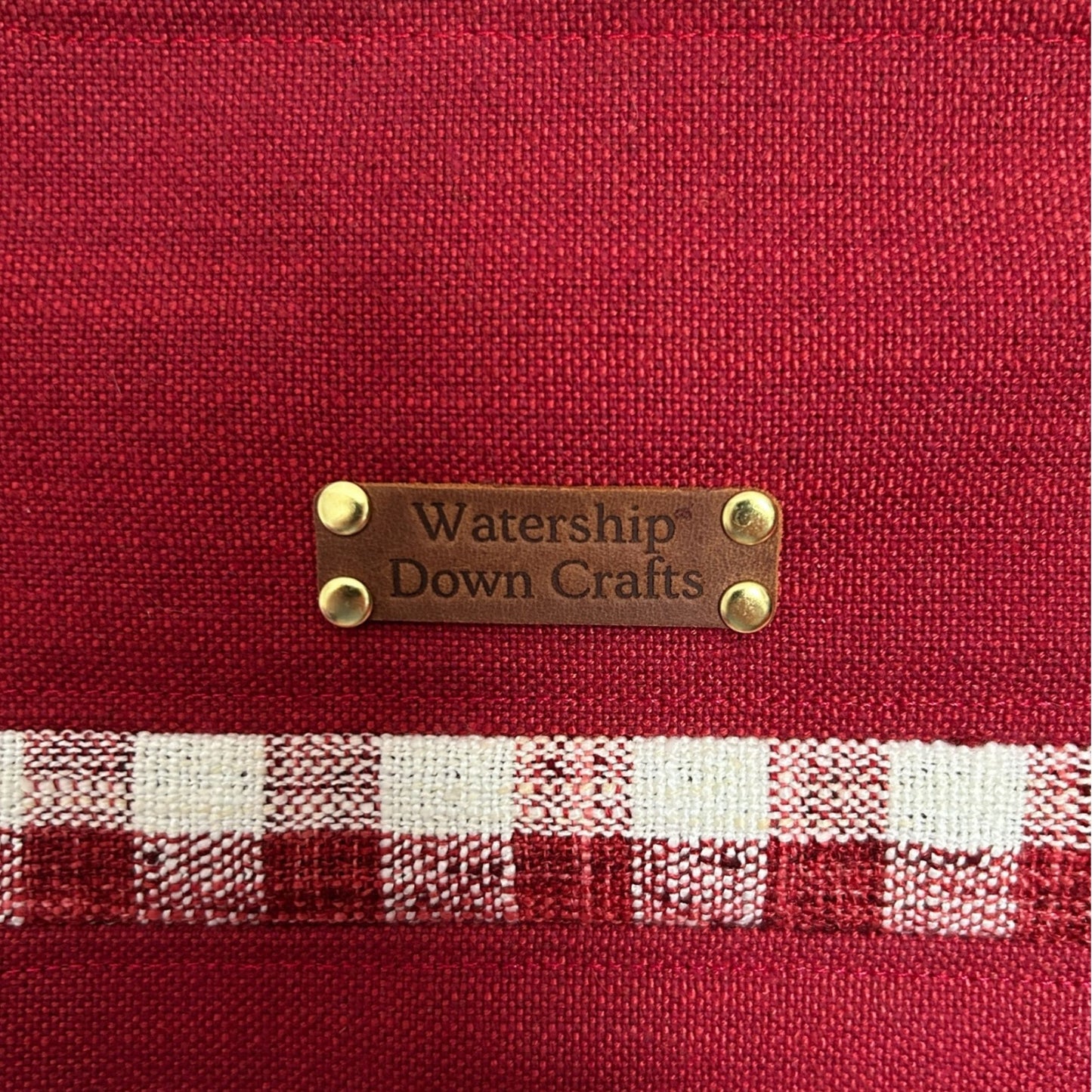 Red fabric with a checkered pattern and 'Watership Down Crafts' label.