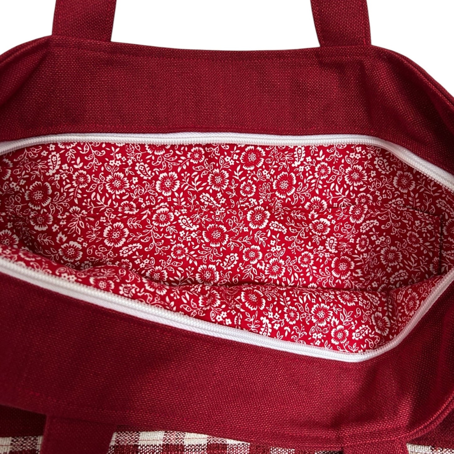 Red bag with floral patterned interior on a white background