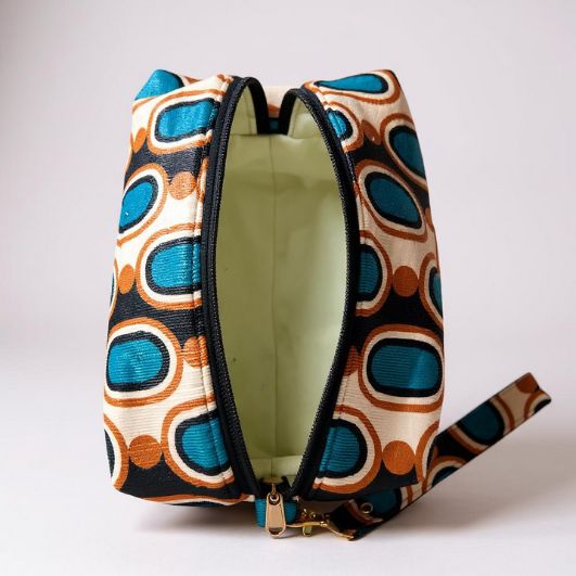 Top-down view of the pouch with zip open, showing the pale green rubber-backed water-resistant lining and spacious interior.
