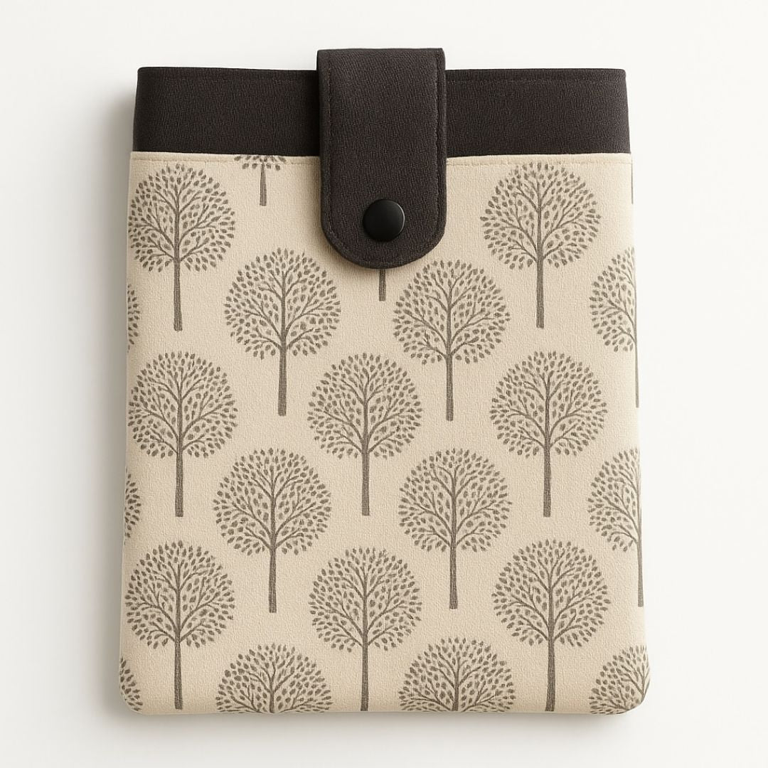 Beige and dark grey tree print tablet case with snap closure and front pocket, made from repurposed fabric
