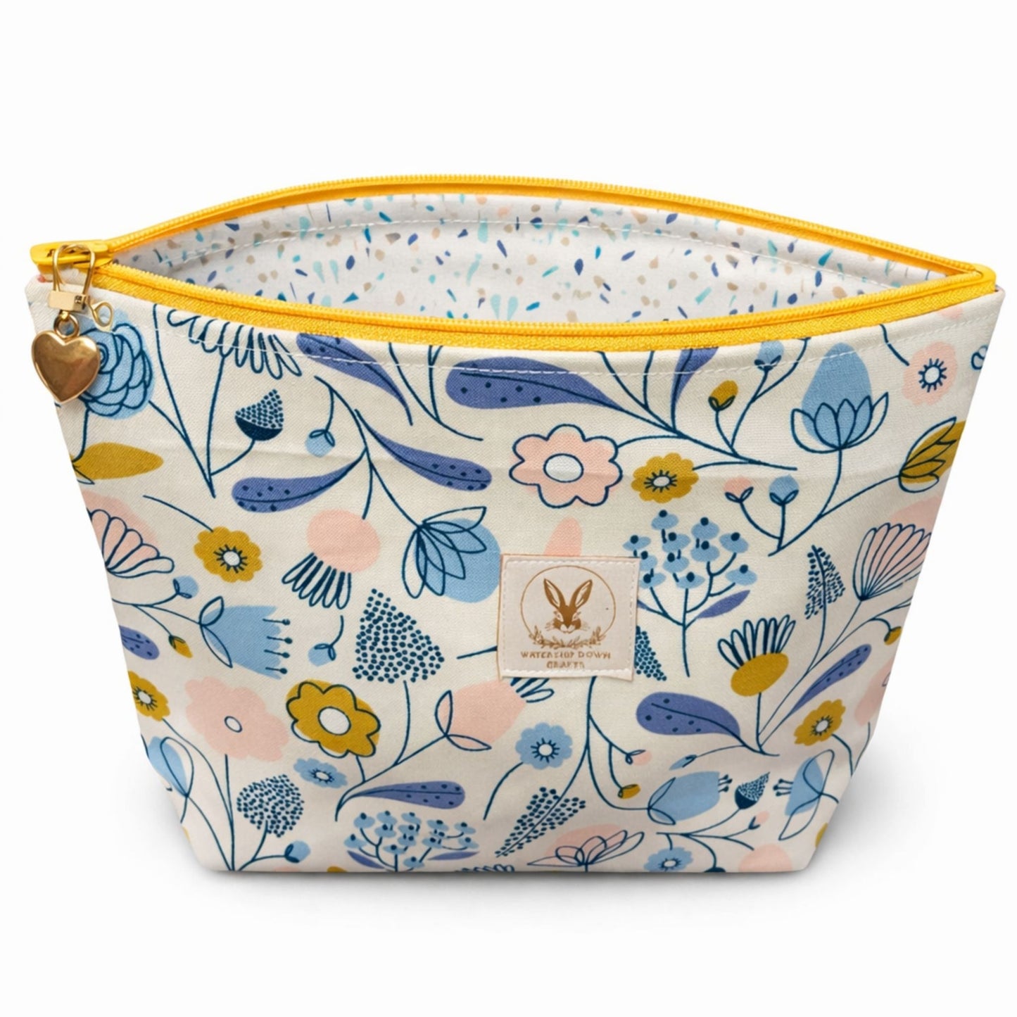 Floral-patterned pouch with yellow zipper on a white background