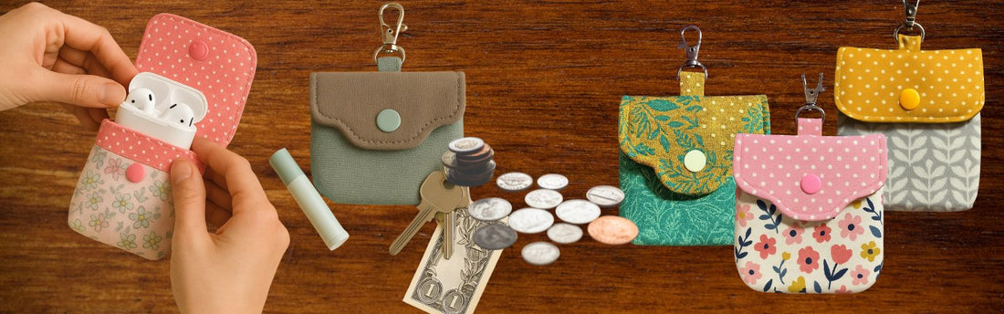 Handmade fabric coin purses made using the coin purse sewing pattern, shown holding items like earbuds, coins, and keys. Each purse has a snap fastening and clip, displayed in assorted fabrics on a wooden background.