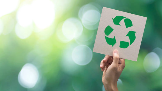 Hand holding a Recycling sign