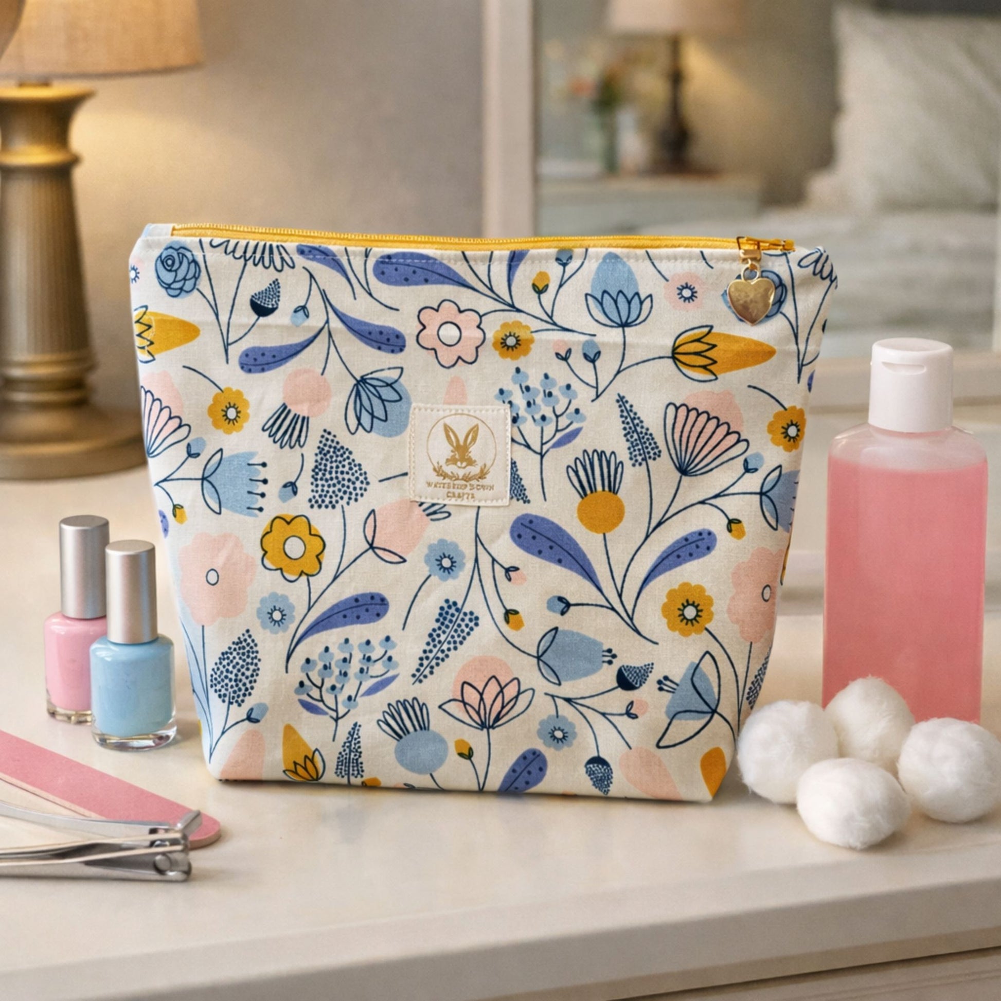 Floral-patterned makeup bag on a table with cosmetic items