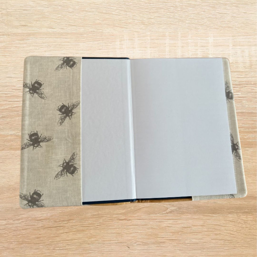 Interior view of the A5 notebook showing the lined hardback notebook inside the bee print fabric cover.