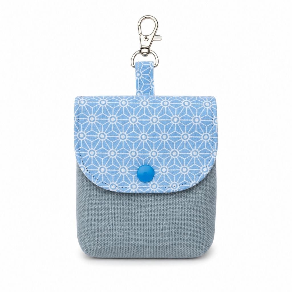 Small fabric pouch with blue geometric pattern and gray base on a white background