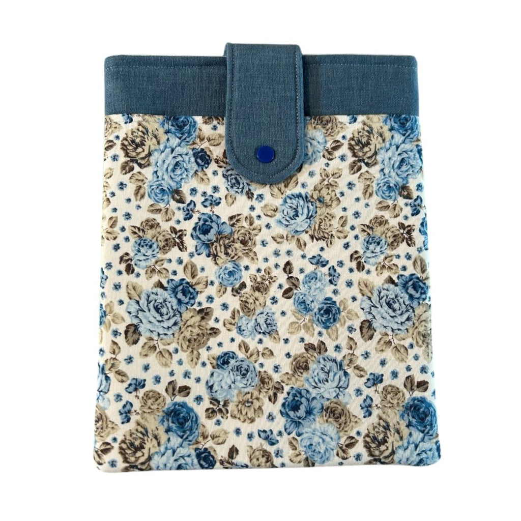 Blue floral tablet sleeve with snap closure and denim-style top trim, handmade from repurposed fabric.