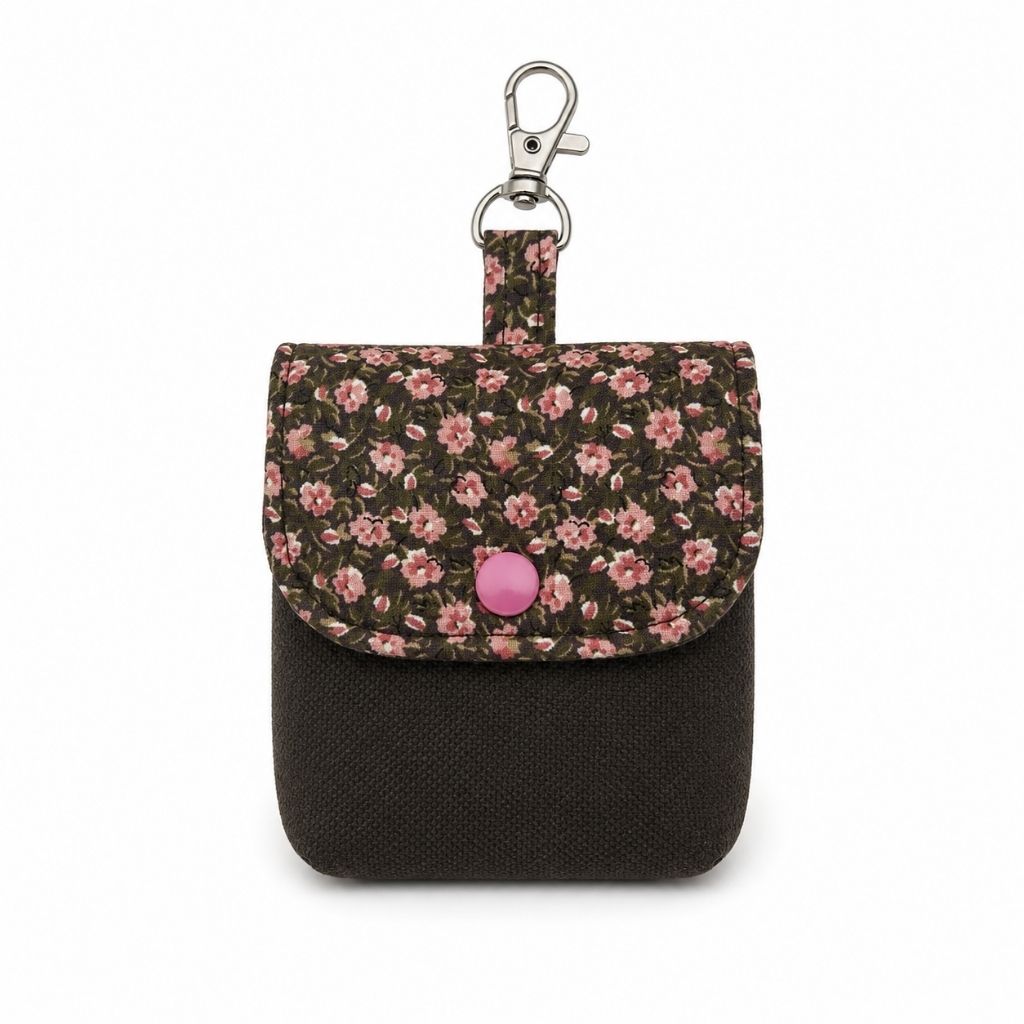 Small pouch with floral top and black bottom on a white background
