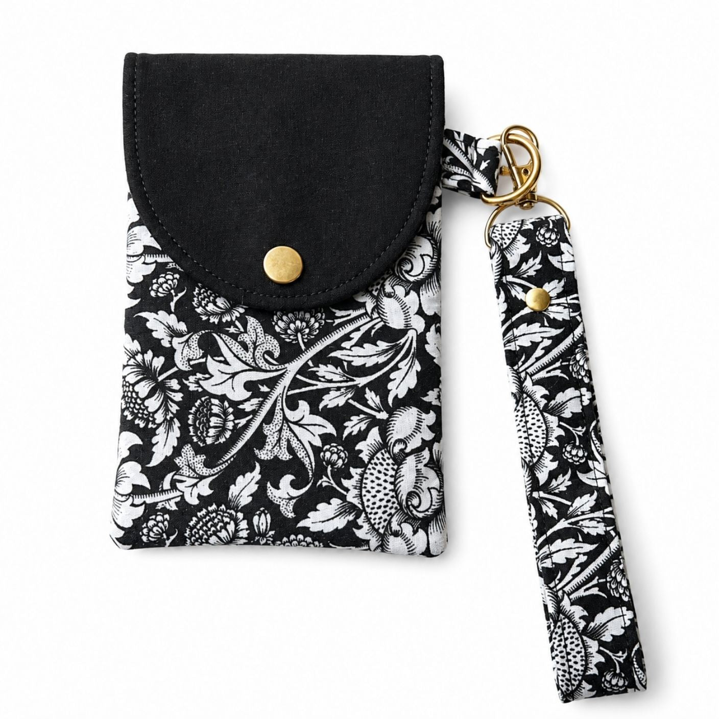 Black phone pouch with floral patterned strap on a white background
