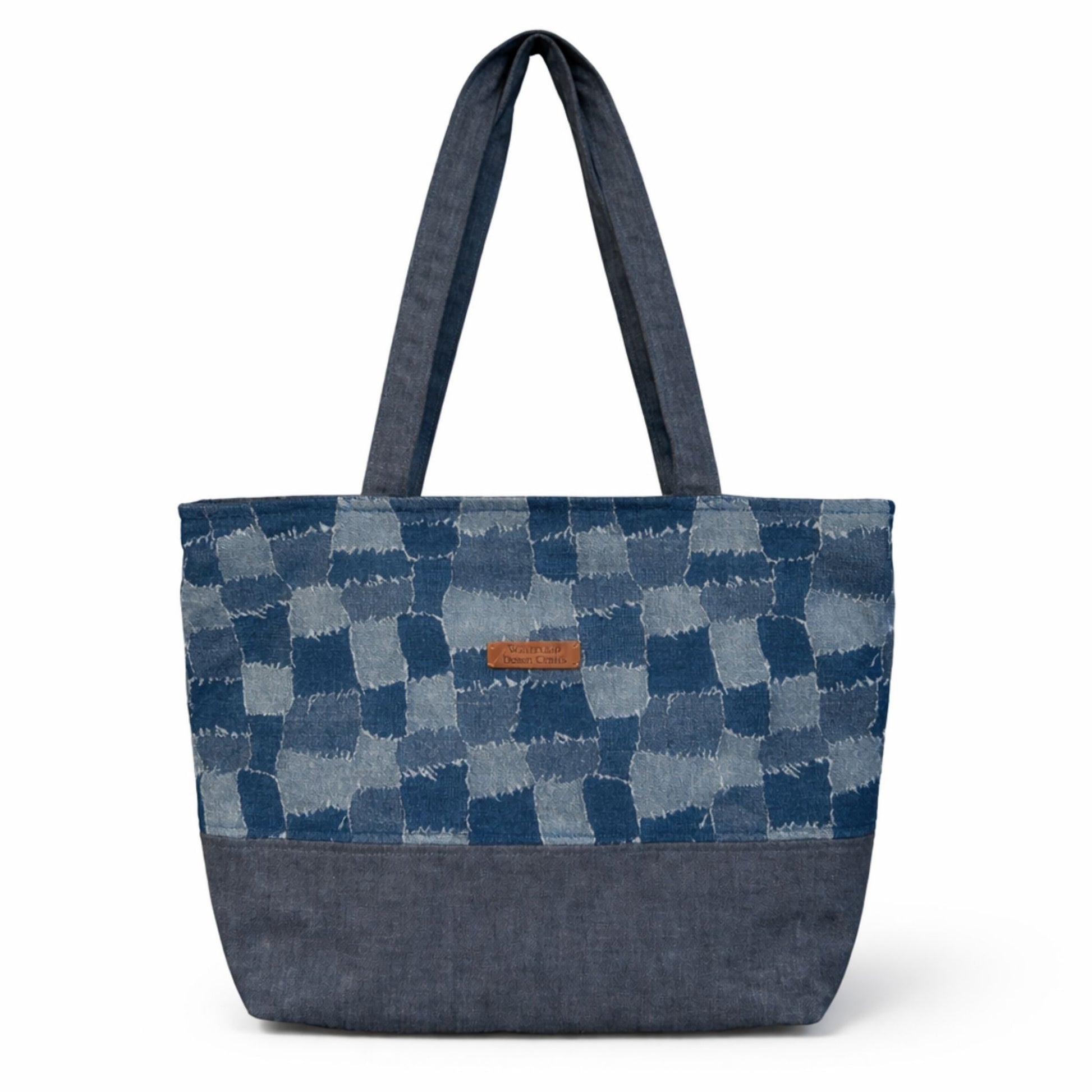 Blue patchwork tote bag with a visible brand label on a white background