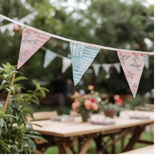 Decorative bunting over a garden table with outdoor setting