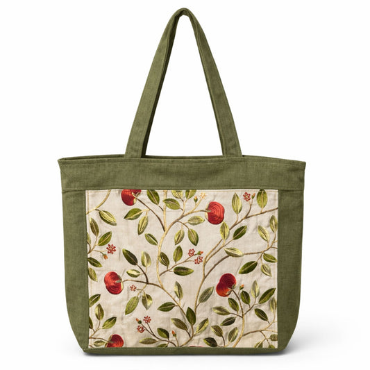 Green tote bag with floral pattern on a white background