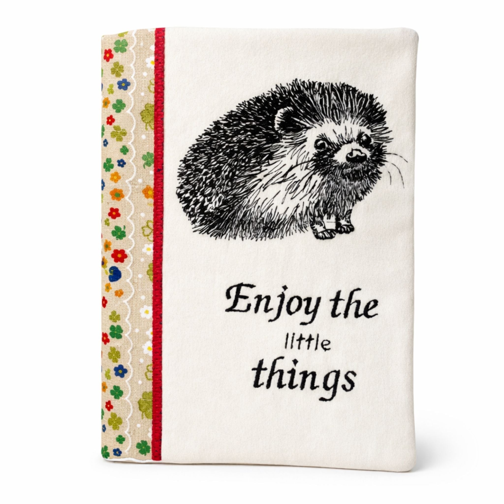 notebook cover with hedgehog embroidery and 'Enjoy the little things' on a white background