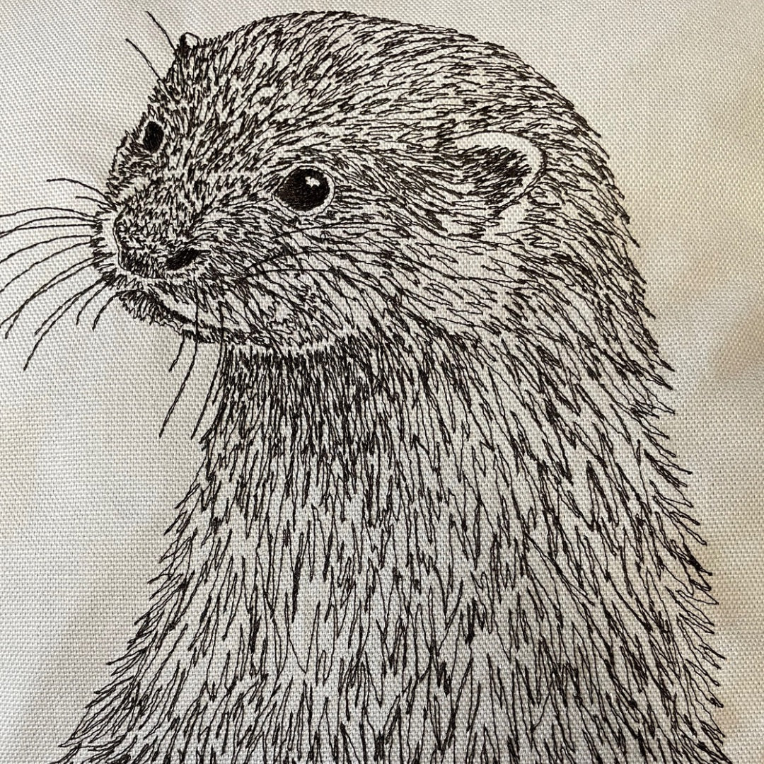 close up of embroidered sketch of an otter