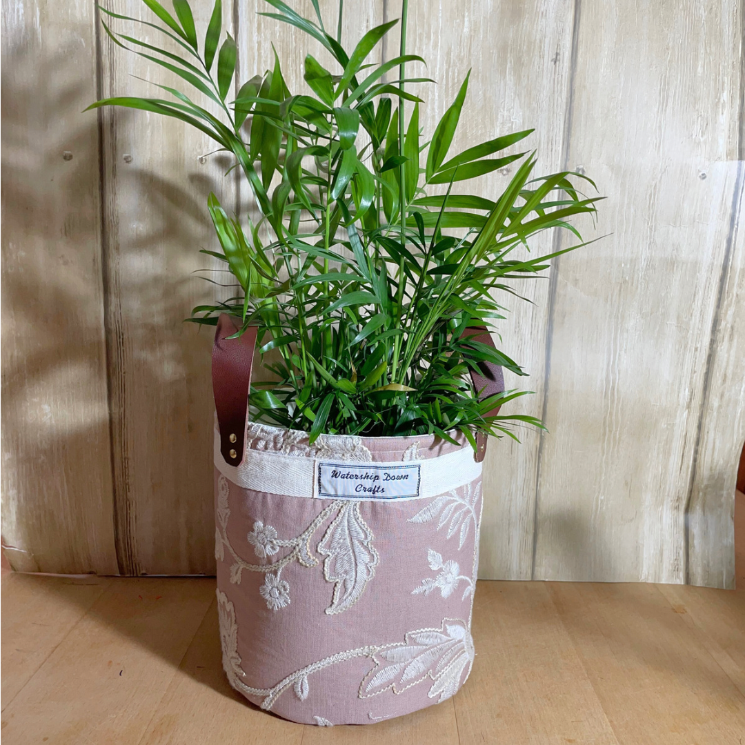 Handmade crewel embroidered fabric basket with indoor plant