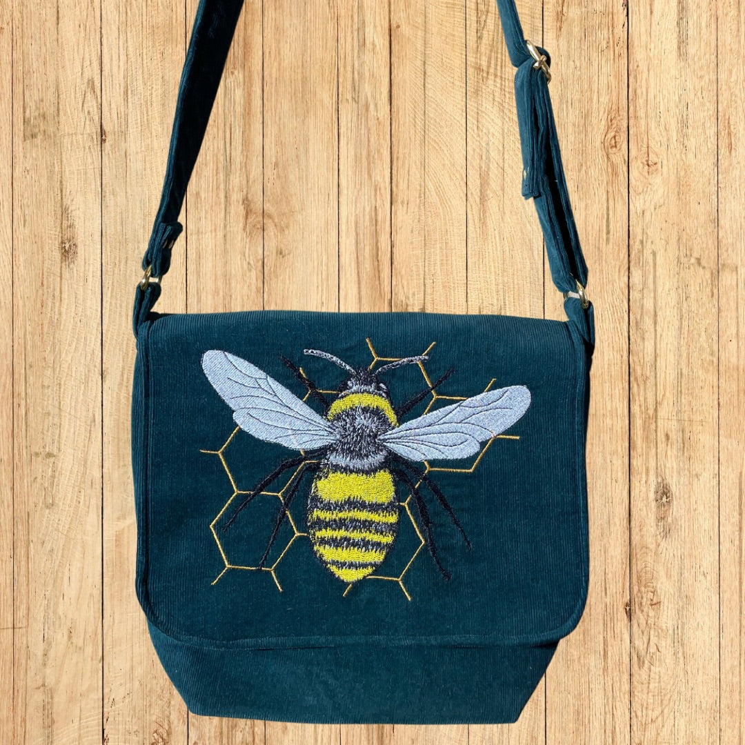 Green Corduroy Messenger Bag with Bee on Honeycomb embroidery hanging