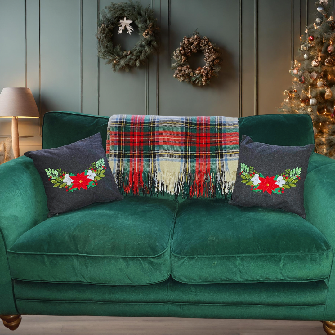 two Christmas cushion with appliqued flowers and leaves on a green sofahandmade