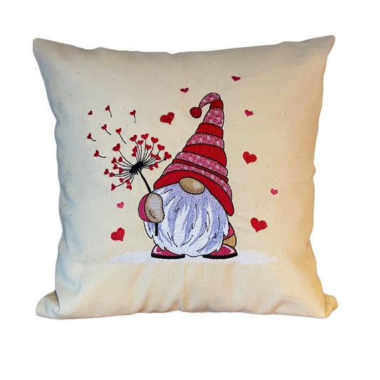 Canvas cushion with embroidered gnome holding a dandelion with heart shaped seeds