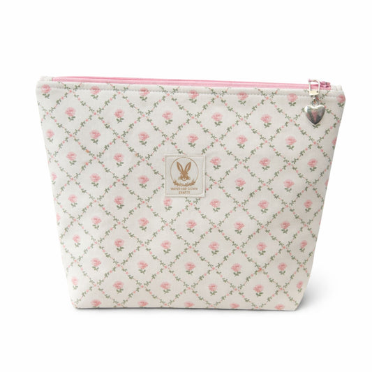 Floral patterned pouch with a pink zipper on a white background