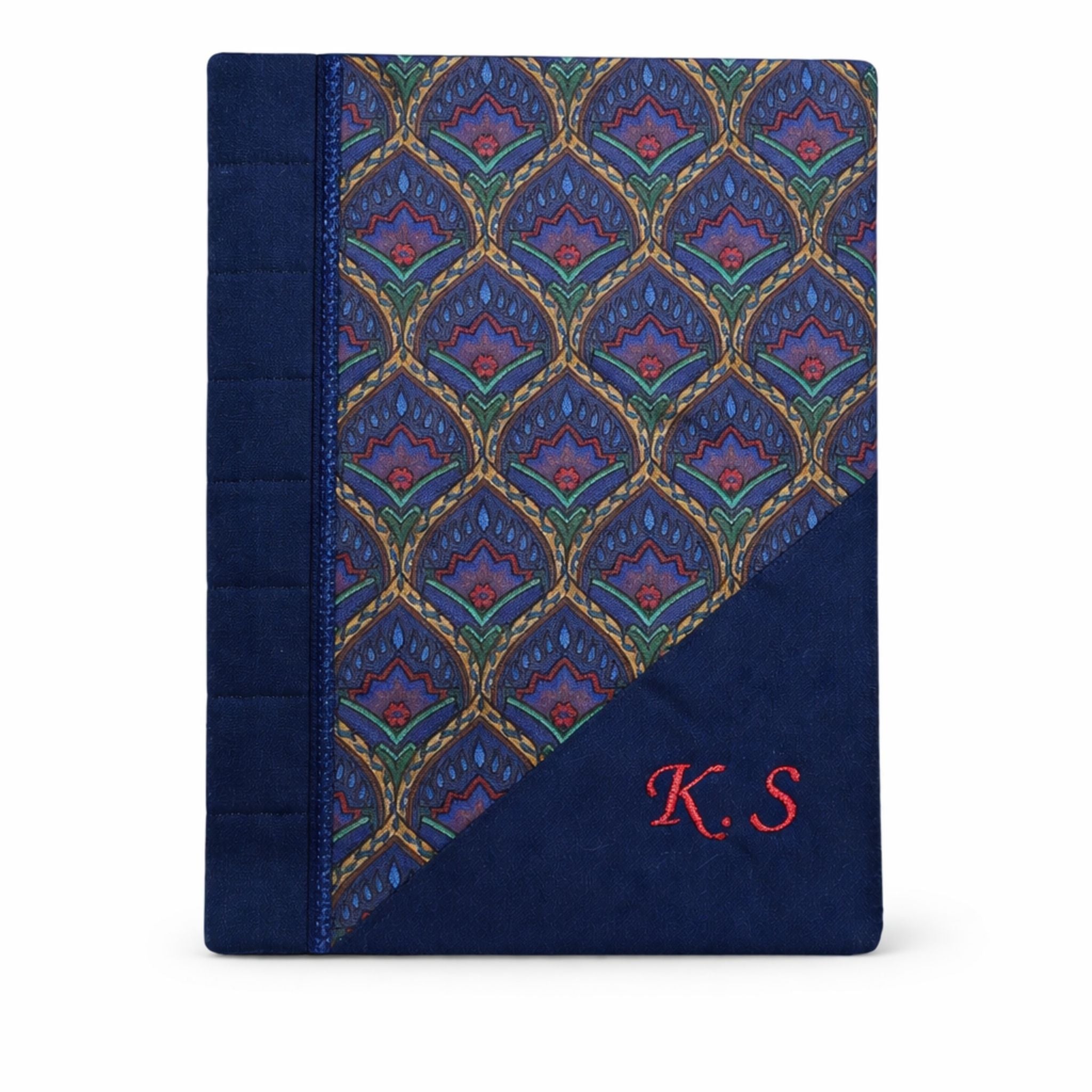Navy blue fabric cover with a patterned design and 'K.S' initials on a white background