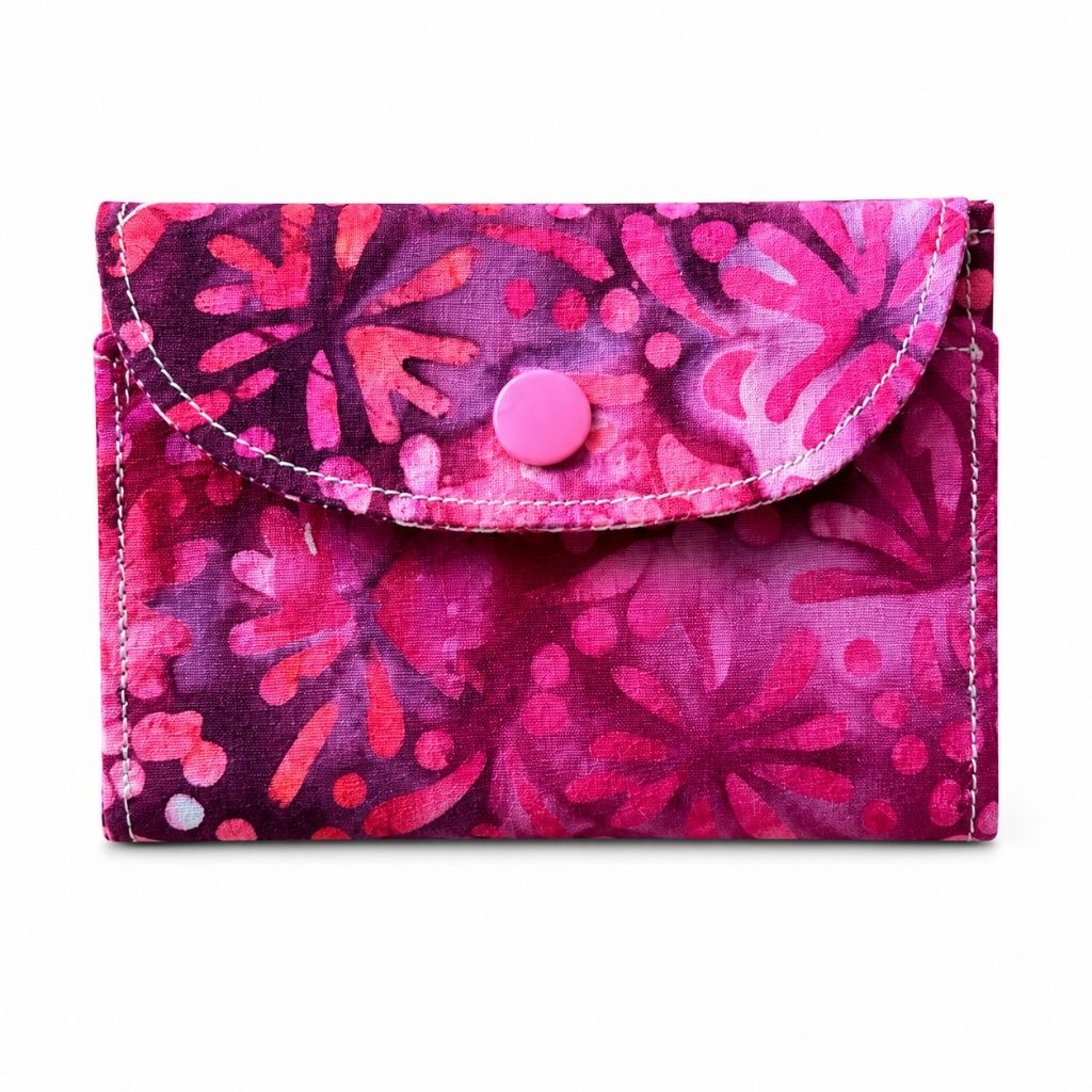 Pink floral patterned wallet on a white background