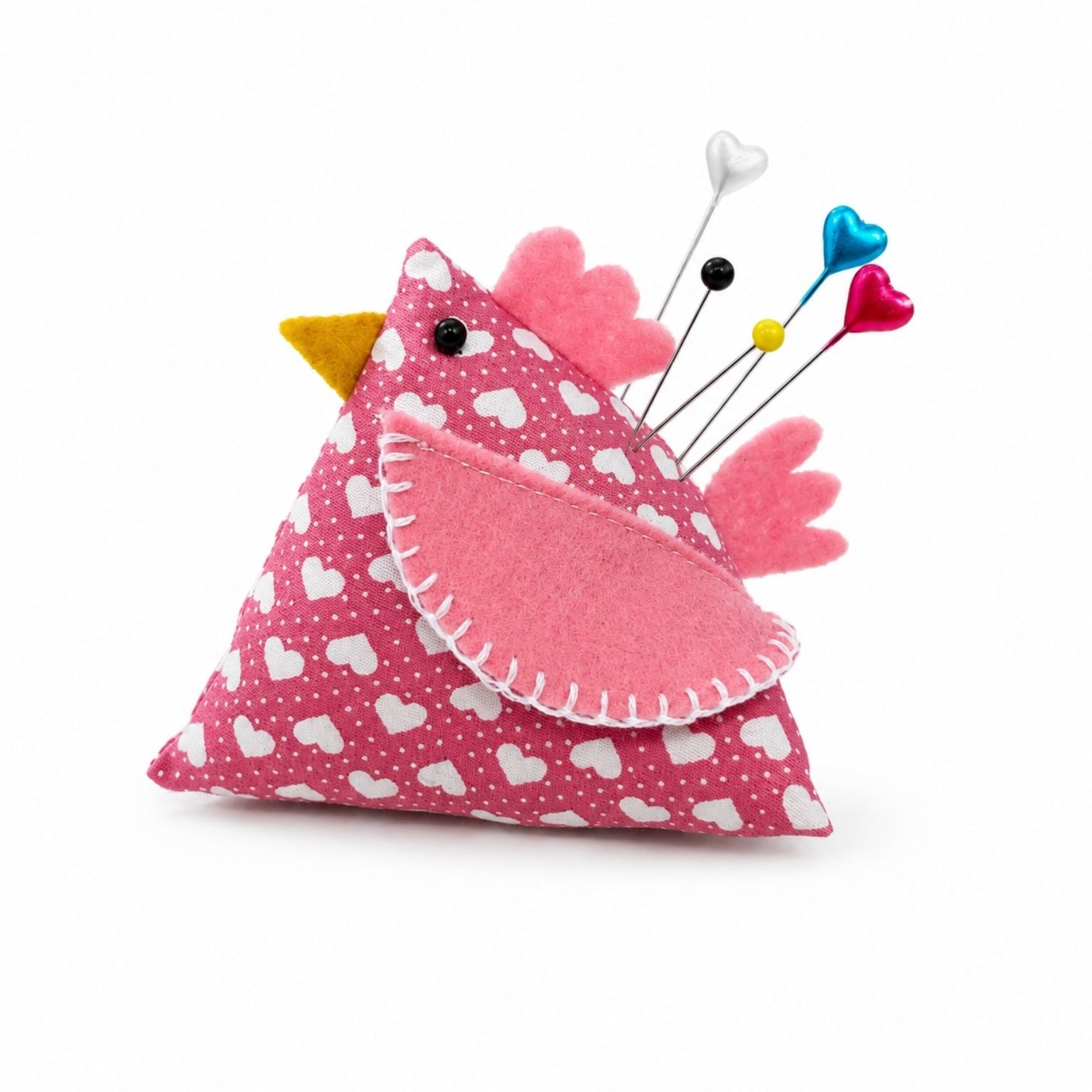 Pink chicken-shaped pincushion with colorful pins on a white background