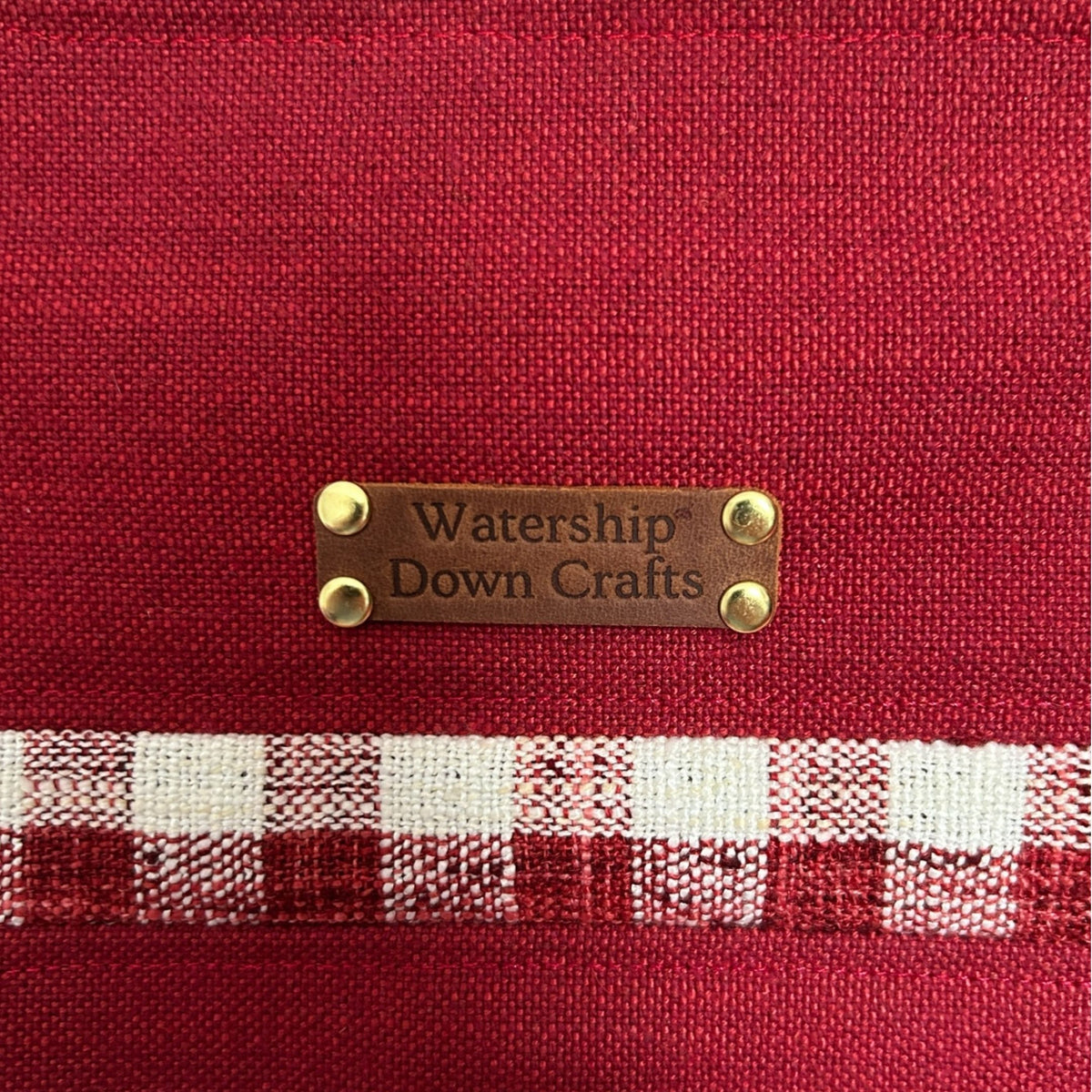 Red fabric with a checkered pattern and 'Watership Down Crafts' label.