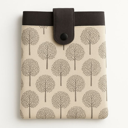 Beige and dark grey tree print tablet case with snap closure and front pocket, made from repurposed fabric