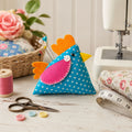 Turquoise Dot Chicken Pincushion on a sewing table
