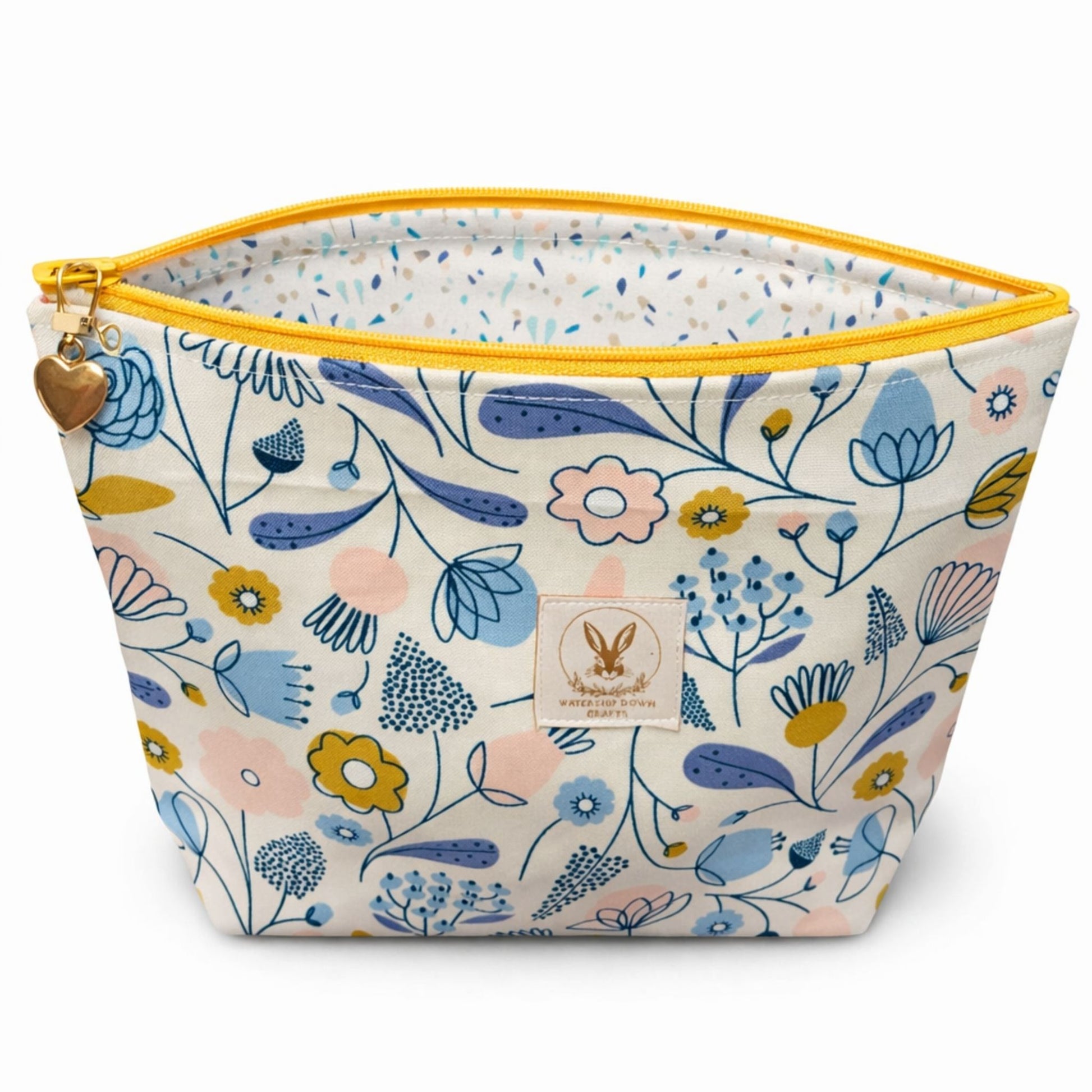 Floral-patterned pouch with yellow zipper on a white background