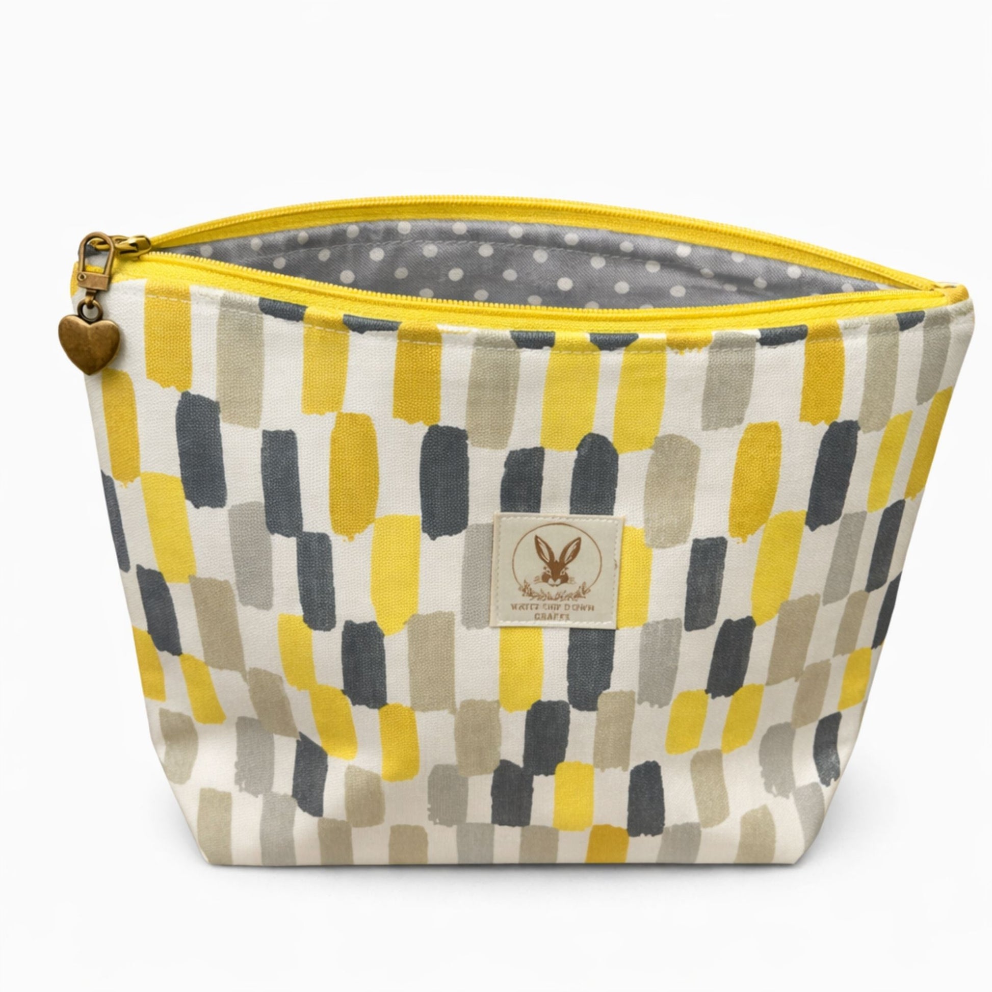 Fabric basket with geometric pattern and yellow zipper on a white background